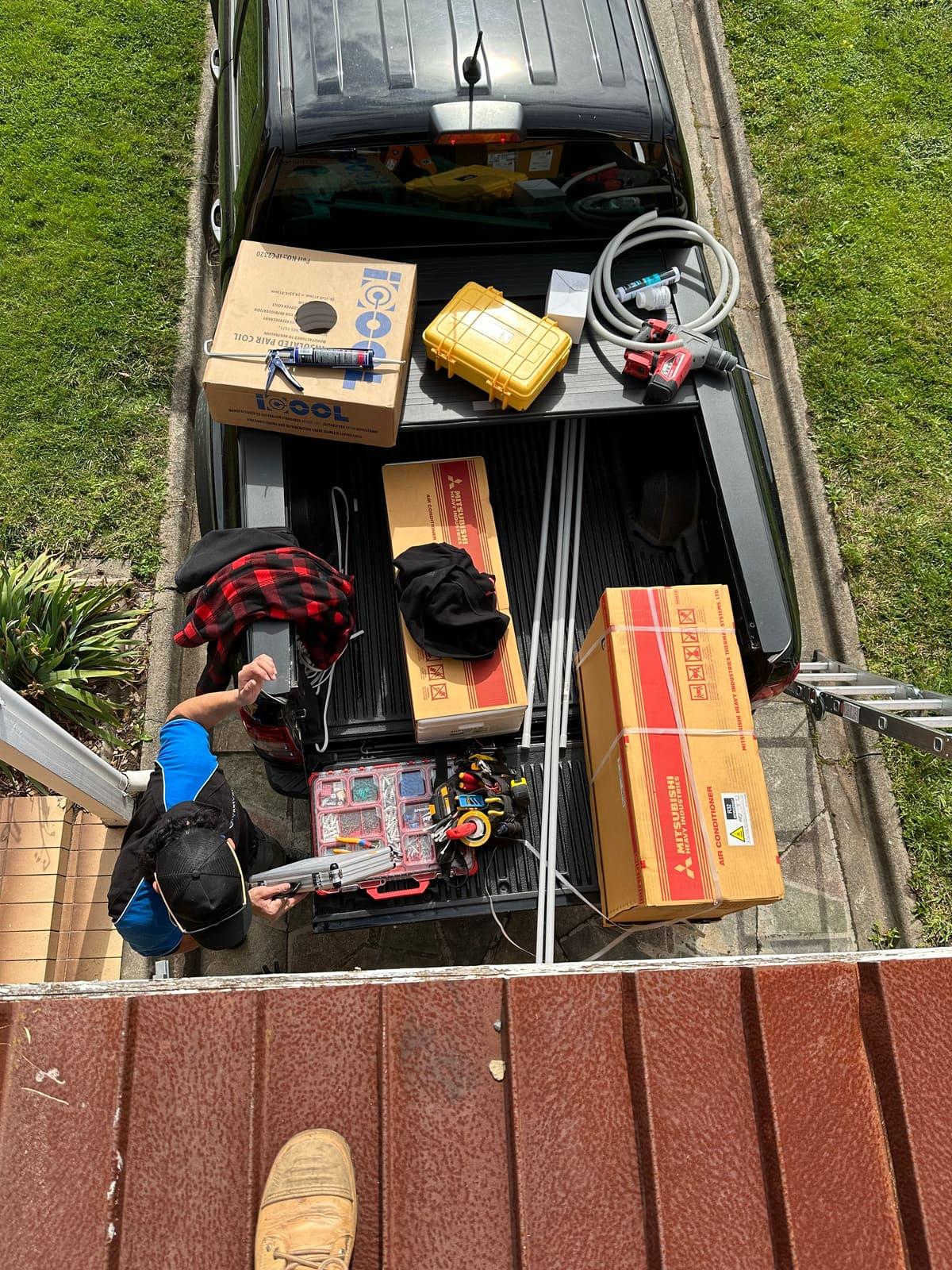 True Line ute loaded with Mitsubishi split systems and tools on installation day