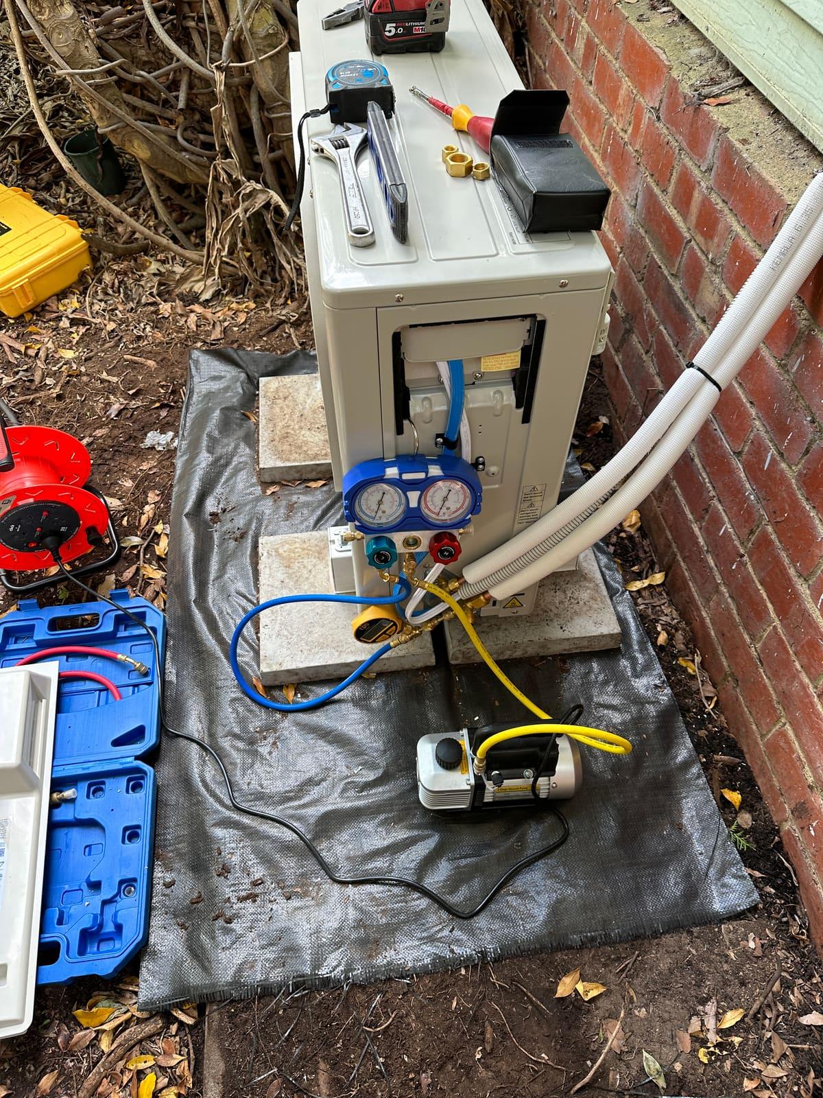 Vacuum and pressure testing the refrigerant lines during a split system installation